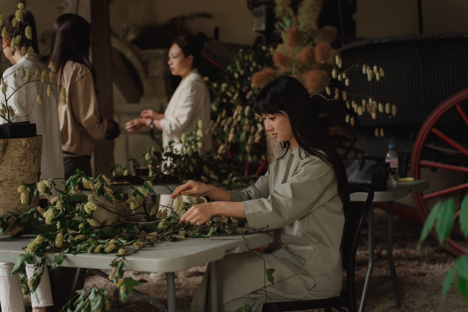 Florist arranging flowers during a workshop at Instinct Florist School