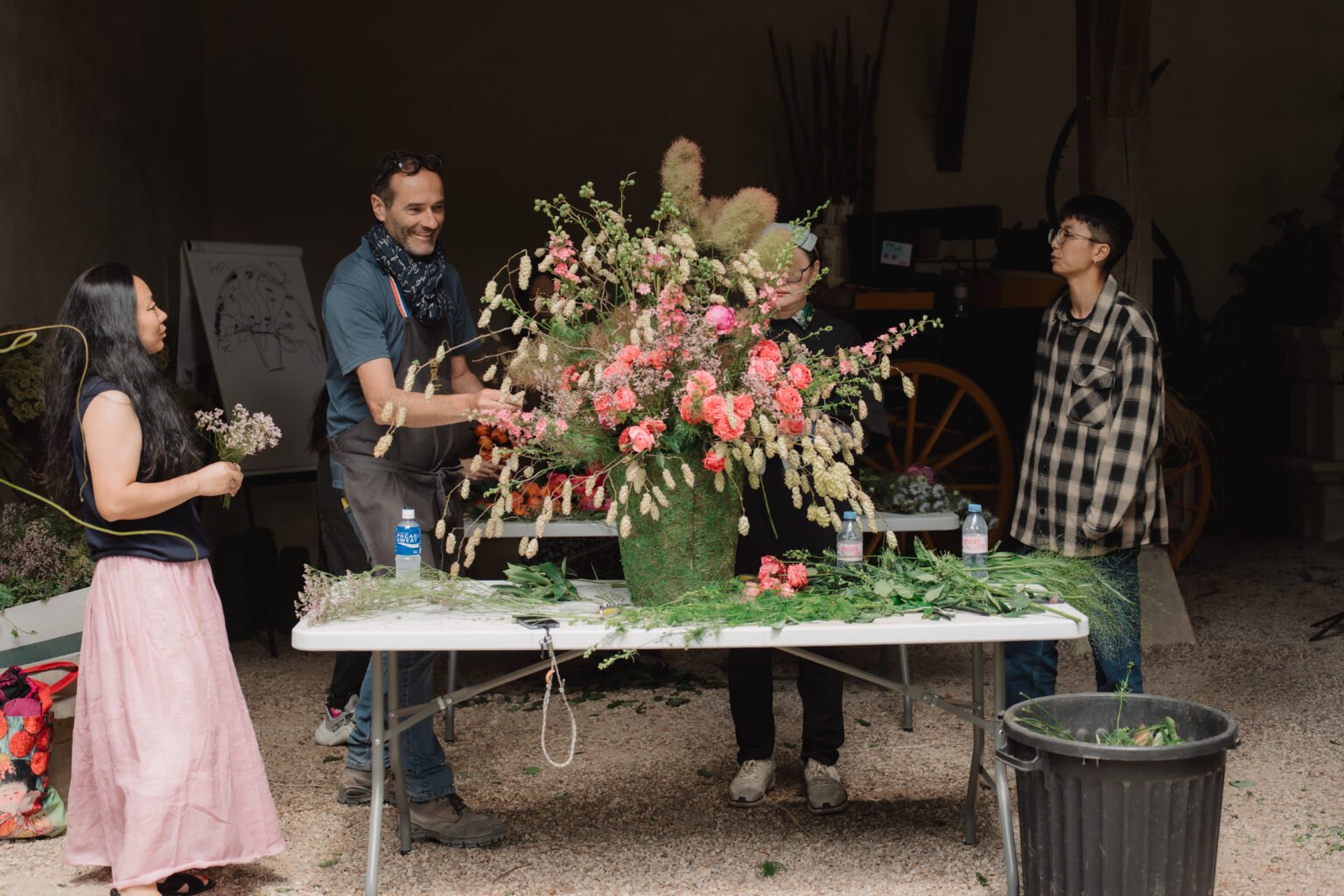 Floristry instructor demonstrating a large floral installation