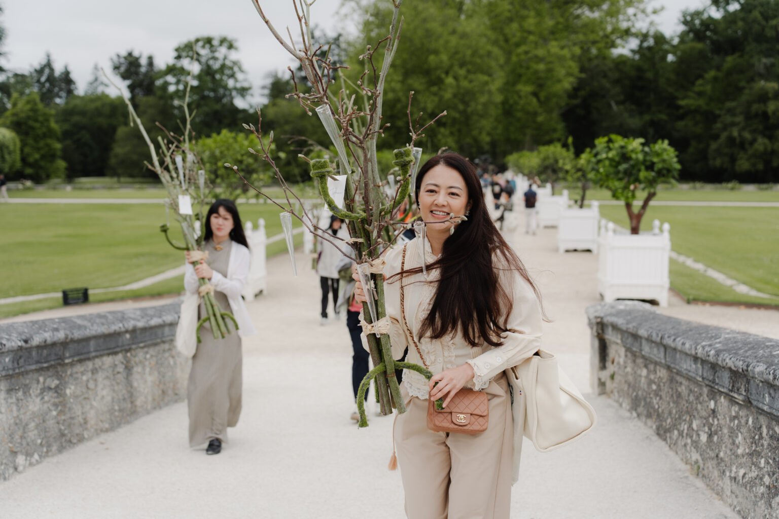 Student carrying flowers on a château terrace