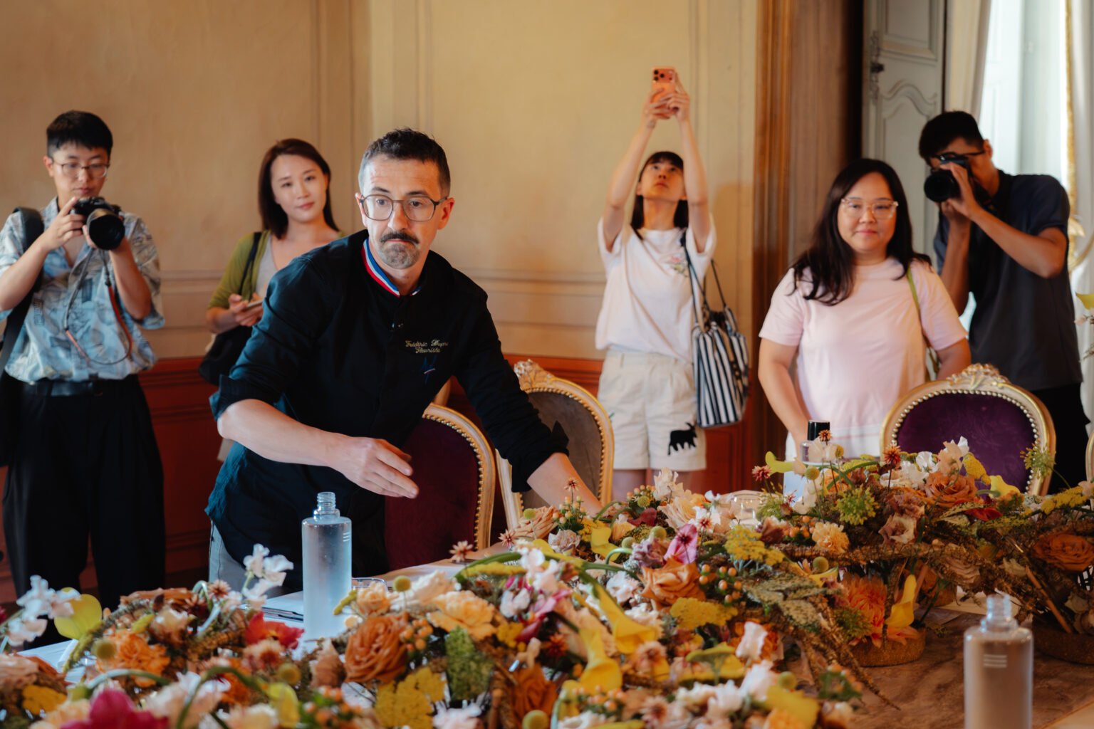 Instructor leading a floral table demonstration for students