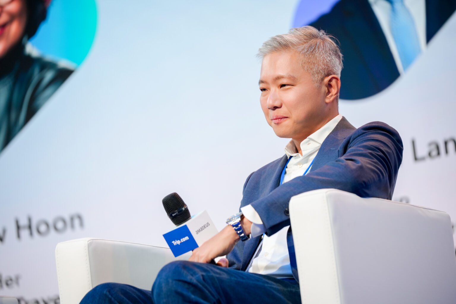 Conference executive seated on the Trip.com stage